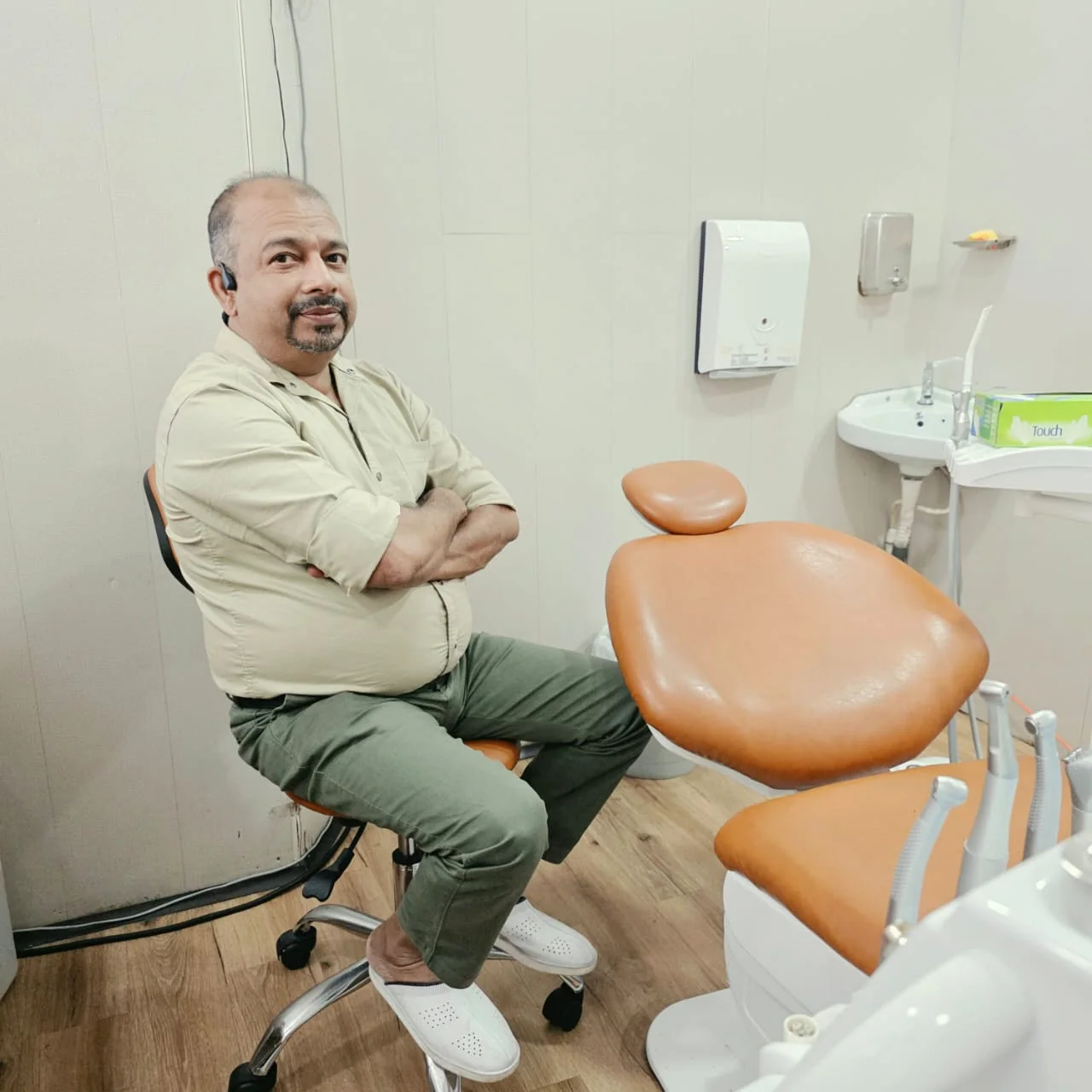 Dr. Jayasooriya seated in the treatment room